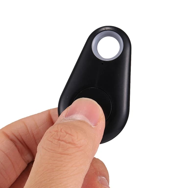 The tag held between two fingers while the button is pressed
