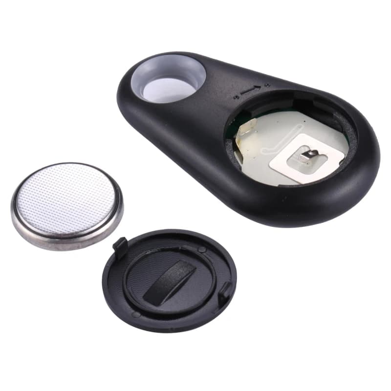 The tag opened: the coin battery, the cover and the inside