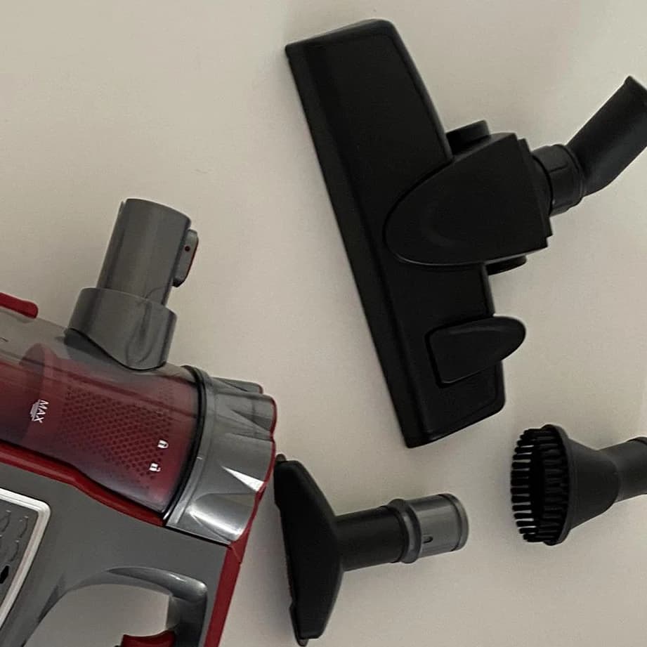 Floor brush and nozzles beside the body of the vacuum