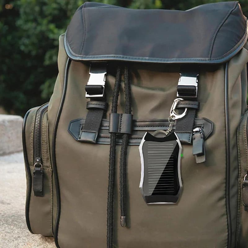 The power bank hanging from a backpack outdoors